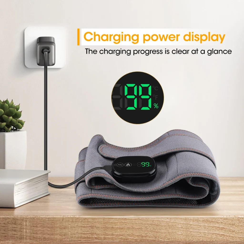 Folded gray massage belt plugged in and charging with 99% battery on screen 